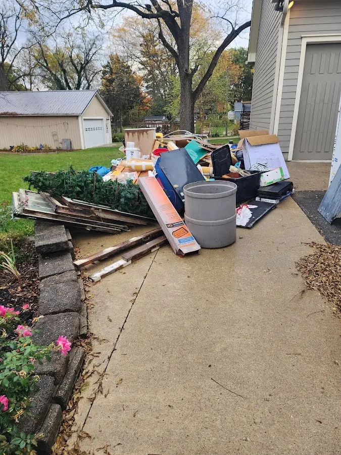 Dumpster being loaded with debris for 10 Yard Dumpster Rental in Prairieville